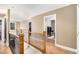 Upstairs hallway with wood railing, hardwood floors, and neutral walls at 1156 Magnolia Dr, Villa Rica, GA 30180