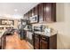 Well-equipped kitchen featuring dark wood cabinetry, granite countertops, and stainless steel appliances at 1156 Magnolia Dr, Villa Rica, GA 30180