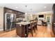 Spacious kitchen featuring granite countertops, stainless steel appliances, and an island with seating, flowing into the living area at 1156 Magnolia Dr, Villa Rica, GA 30180