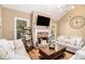 Inviting living room featuring a stone fireplace, vaulted ceiling, and comfortable seating at 1156 Magnolia Dr, Villa Rica, GA 30180