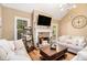 Inviting living room with a fireplace, neutral tones, hardwood floors, and abundant natural light at 1156 Magnolia Dr, Villa Rica, GA 30180