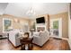 Cozy living room with a brick fireplace, neutral decor, and plenty of natural light at 1156 Magnolia Dr, Villa Rica, GA 30180