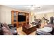 Spacious living room with wooden floors, entertainment center, and comfortable brown couches at 1156 Magnolia Dr, Villa Rica, GA 30180