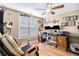 Comfortable home office featuring a ceiling fan, natural light, and hardwood floors at 1156 Magnolia Dr, Villa Rica, GA 30180