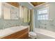 Charming bathroom with vintage details: blue tile, glass block window, unique sink vanity, and wood ceiling at 2669 Jefferson Terrace Ter, East Point, GA 30344