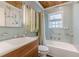 Charming bathroom with vintage details: blue tile, glass block window, unique sink vanity, and wood ceiling at 2669 Jefferson Terrace Ter, East Point, GA 30344