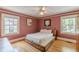 Bedroom features hardwood floors, natural light from two windows, and modern artwork at 2669 Jefferson Terrace Ter, East Point, GA 30344