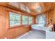 Bright bedroom featuring wood paneled walls and lots of light from multiple windows at 2669 Jefferson Terrace Ter, East Point, GA 30344