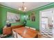 Dining room with green walls, wood table, and decorative art, creating an inviting atmosphere at 2669 Jefferson Terrace Ter, East Point, GA 30344