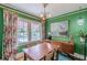 Bright dining room with large windows, green walls, hardwood floors and vintage chandelier at 2669 Jefferson Terrace Ter, East Point, GA 30344