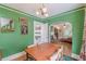 Green dining room featuring hardwood floors, dining table and chairs that opens to the living room at 2669 Jefferson Terrace Ter, East Point, GA 30344