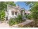 Charming bungalow home with white siding, pink awnings, mature landscaping and inviting front porch at 2669 Jefferson Terrace Ter, East Point, GA 30344