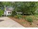 A charming home with a well-manicured front yard, showcasing a vibrant garden and a spacious driveway at 2669 Jefferson Terrace Ter, East Point, GA 30344