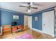 Blue Office with hardwood floors, built in bookshelves, and desk at 2669 Jefferson Terrace Ter, East Point, GA 30344