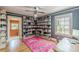 Inviting office with hardwood floors, blue walls, and full wall of bookshelves at 2669 Jefferson Terrace Ter, East Point, GA 30344