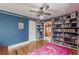 Stylish office with hardwood floors, blue walls, and full wall of bookshelves at 2669 Jefferson Terrace Ter, East Point, GA 30344