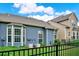 Attractive backyard features a well-manicured lawn, iron fence, and neighboring building exterior at 2685 Sardis Chase Ct, Buford, GA 30519