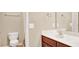 Functional bathroom featuring a toilet, vanity with sink, mirror, and towel racks at 2685 Sardis Chase Ct, Buford, GA 30519