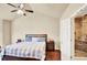Vaulted ceiling bedroom featuring hardwood floors, ceiling fan, and en-suite bath with glass shower at 2685 Sardis Chase Ct, Buford, GA 30519