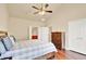 Bedroom with ceiling fan, hardwood floors, dresser, and en-suite bathroom and closet at 2685 Sardis Chase Ct, Buford, GA 30519
