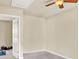 Spare bedroom with door leading to exercise room, carpeted floor, and ceiling fan at 2685 Sardis Chase Ct, Buford, GA 30519