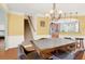 Bright dining room with hardwood floors, and direct sightlines to the staircase and updated kitchen at 2685 Sardis Chase Ct, Buford, GA 30519