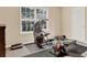 Home gym space features a workout machine, rubber mats, and plenty of natural light at 2685 Sardis Chase Ct, Buford, GA 30519