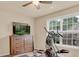 Bright home gym space includes a workout machine, dresser, and views to outside at 2685 Sardis Chase Ct, Buford, GA 30519