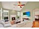 Comfortable living room with a fireplace, large windows, and hardwood floors, perfect for relaxing at 2685 Sardis Chase Ct, Buford, GA 30519