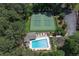 Overhead view of community pool, tennis courts, surrounded by lush trees at 4655 Latimer Ne Ct, Kennesaw, GA 30144