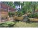 Backyard featuring stone retaining walls, mature trees, and screened porch at 4655 Latimer Ne Ct, Kennesaw, GA 30144
