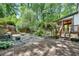 Backyard with a wooden deck, stairs, stone landscaping, and mature trees at 4655 Latimer Ne Ct, Kennesaw, GA 30144