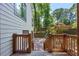 Backyard featuring a wood staircase leading to a landscaped yard and trees at 4655 Latimer Ne Ct, Kennesaw, GA 30144
