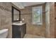 Tiled bathroom featuring a vanity, decorative mirror, and a window at 4655 Latimer Ne Ct, Kennesaw, GA 30144