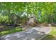 Beautiful two-story home featuring mature trees and stone driveway at 4655 Latimer Ne Ct, Kennesaw, GA 30144
