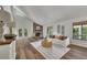 Cozy living room features a stone fireplace, shiplap accent walls, hardwood flooring, and lots of natural light at 4655 Latimer Ne Ct, Kennesaw, GA 30144