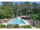 Community pool area with lounge chairs, umbrellas and covered seating at 4655 Latimer Ne Ct, Kennesaw, GA 30144