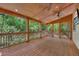 Screened-in porch with wood ceiling, ceiling fans, and views of the backyard at 4655 Latimer Ne Ct, Kennesaw, GA 30144