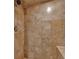 Shower stall featuring travertine tile and a shower head at 4655 Latimer Ne Ct, Kennesaw, GA 30144