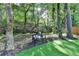 Backyard with a bench among the trees at 10000 Barston Ct, Johns Creek, GA 30022