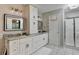 Bathroom featuring marble countertops, updated fixtures, shower with glass door, and a tile floor at 10000 Barston Ct, Johns Creek, GA 30022