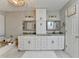 Bathroom showcasing marble countertops, custom cabinets, updated fixtures, and a jacuzzi tub at 10000 Barston Ct, Johns Creek, GA 30022