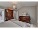 Bedroom showcasing a decorative chandelier, and large dresser with access to the bathroom at 10000 Barston Ct, Johns Creek, GA 30022