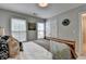 Bedroom featuring a wooden bed frame, natural light from the windows, and neutral paint at 10000 Barston Ct, Johns Creek, GA 30022