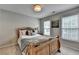 Bedroom featuring a wooden bed frame, natural light from the windows, and neutral paint at 10000 Barston Ct, Johns Creek, GA 30022