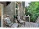 Outdoor deck with comfortable seating, ideal for enjoying nature and fresh air at 10000 Barston Ct, Johns Creek, GA 30022