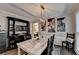 Dining room featuring art, hardwood floors, and modern decorative hutch at 10000 Barston Ct, Johns Creek, GA 30022