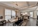 A dining room boasting a view of an adjacent sitting room and hardwood floors at 10000 Barston Ct, Johns Creek, GA 30022