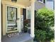 Welcoming front door with a decorative wreath, potted plants, and a charming 'Friends' sign at 10000 Barston Ct, Johns Creek, GA 30022