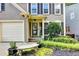Inviting home entrance with landscaped garden and bench, creating a welcoming atmosphere at 10000 Barston Ct, Johns Creek, GA 30022